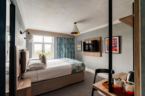a hotel room with a bed and a window at Craig Manor in Bowness-on-Windermere