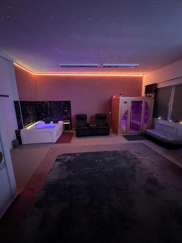 a large living room with a tub and a table at RelaxCheb Private Wellness Studio in Cheb