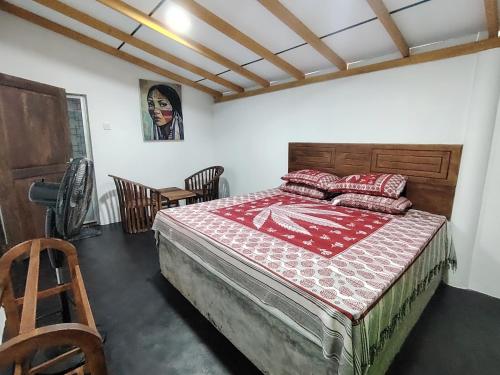 a bedroom with a large bed with red pillows on it at Villa Hide Out in Busse