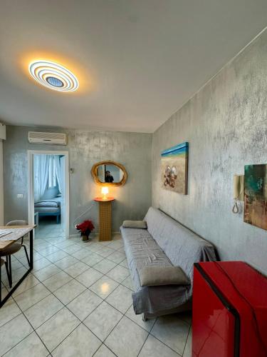a living room with a couch and a table at AppArt 24 city center parking and Sea Design district in Lignano Sabbiadoro