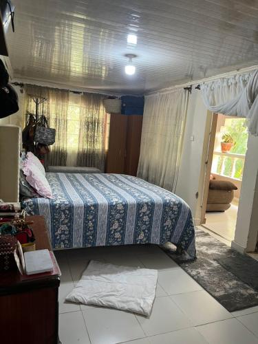 a bedroom with a bed in the middle of a room at Lifeline Homes in Kiserian