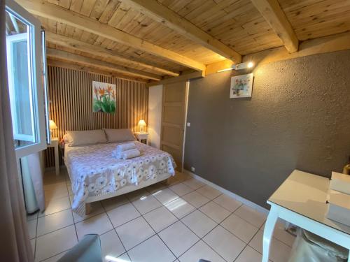 a small bedroom with a bed in a room at Mas de la Vieille Vigne in Argelès-sur-Mer