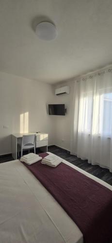 a room with a bed and a desk and a table at Step by step in Scalea