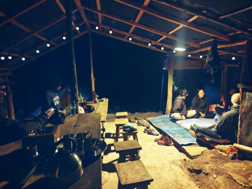 a group of people sitting on a bed in a room at Eco Lodge Haputale-Camping Sri lanka in Haputale