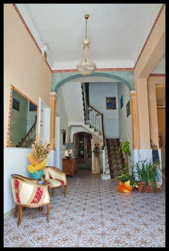 a living room with a couch and a chandelier at Hotel Eros in Lido di Camaiore