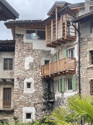 a stone building with wooden balconies on it at Dimora Concordia in Calavino