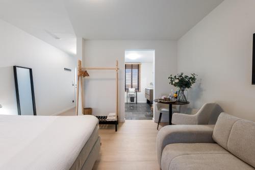 a living room with a bed and a couch at Huys van Haeghe in Zoutleeuw