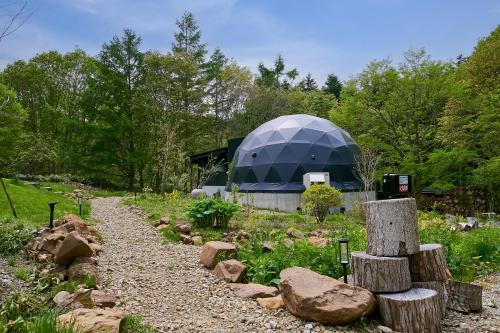 a garden with a dome in the background at villa福座 in Furusan