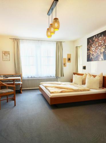 a bedroom with a large bed in a room at Pension Villa Sarah in Bad Dürrheim