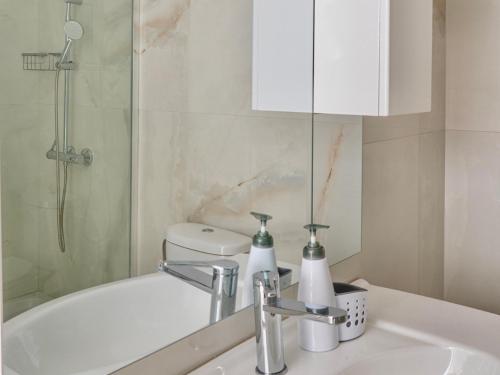 a bathroom with a sink and a shower and a toilet at VASKO Luxury Suites 4 in Siátista