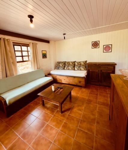 a living room with a couch and a coffee table at Cabana Rosa na mata in Imbituba