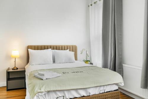 a white bedroom with a large bed with white pillows at West Bridgford Comfort Quality Suites in Nottingham