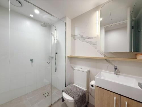a bathroom with a toilet and a sink and a shower at Prospect Box Hill - Magnificent View 2B1B in Box Hill