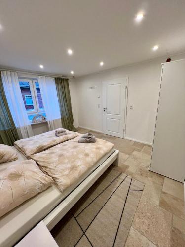 a bedroom with a large bed and a window at Ferienwohnung auf dem Berg in Bad Bentheim