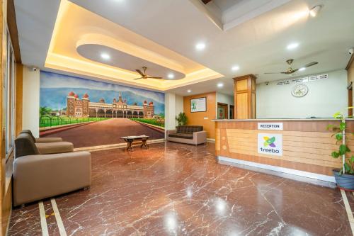 an office lobby with a mural of a building at Treebo Akshaya Palace Inn in Mysore