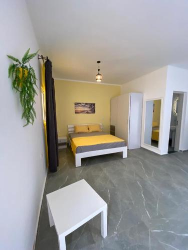 a bedroom with a bed and a table in it at Magawish Hurghada Studio 7 in Hurghada
