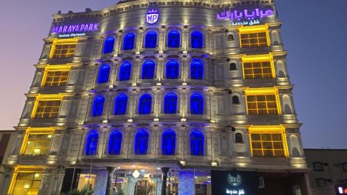 een gebouw met blauwe lichten aan de zijkant bij مرايا بارك in Al Mikhlaf