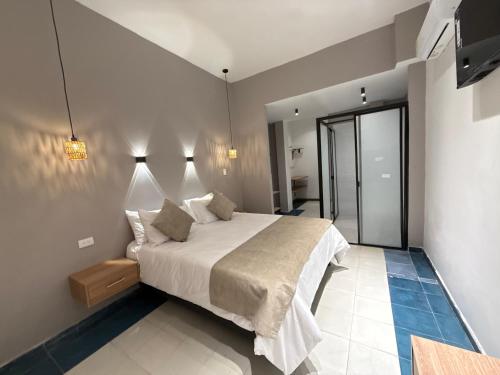 En eller flere senge i et værelse på Hotel B&B Nativo Peñón