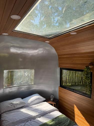 a bedroom with a bed and a large window at Anora Eco-Resort Siquijor in Lazi