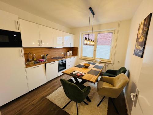 a kitchen with a table and chairs in a room at Marktblick in Esens