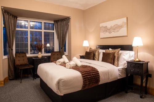 a bedroom with a large bed and a window at Exquisite Bolton House, Garden Living, Parking, Sleeps 7 in Bolton