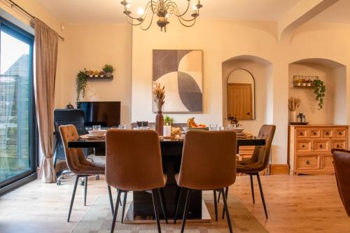 a dining room with a table and chairs at Exquisite Bolton House, Garden Living, Parking, Sleeps 7 in Bolton