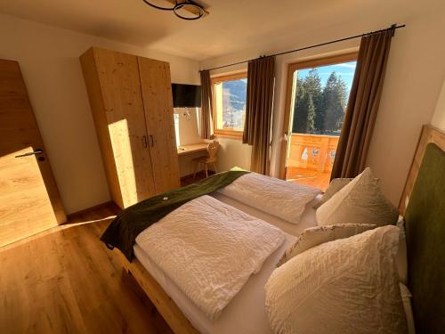 a bedroom with two beds and a window at Wiererhof in Fügenberg