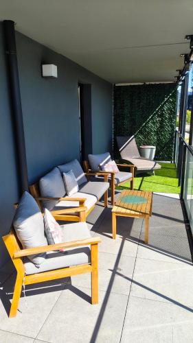 a group of benches sitting on a patio at Vue Parlement Européen - Grande terrasse au calme - Tram à 2 min - Parking in Strasbourg