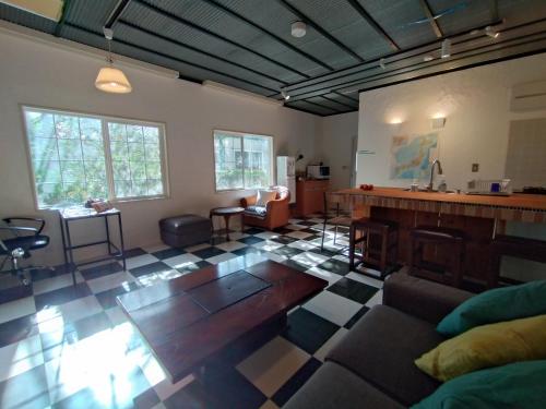 a large living room with a kitchen and a bar at Nemurupa Garden Hostel and Yoga near Narita Airport 15 min Late Check in in Narita