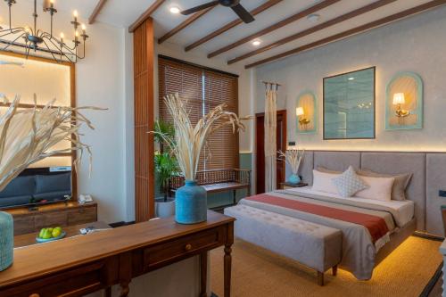 a bedroom with a bed and a tv in a room at Mikayla Cove in Negombo
