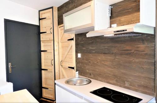 a small kitchen with a sink and a stove at Studio, centre La Bresse in La Bresse