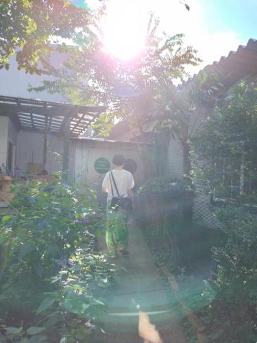 a man riding a bike in a garden at Nemurupa Garden Hostel and Yoga near Narita Airport 15 min Shuttle in Narita