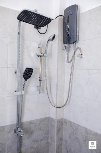 a shower in a bathroom with a phone on the wall at Willow Waters in Galle