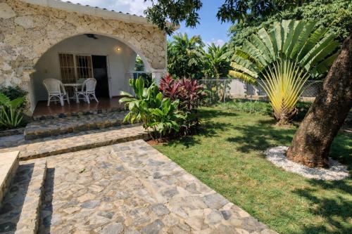 a house with a garden and a patio at Casa los Mangos Private pool 150 m from the beach in Las Galeras