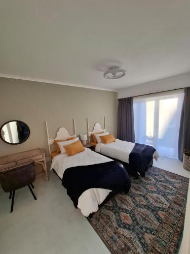 a hotel room with two beds and a window at Embrace This Planet Self-Catering Accommodation in Fisherhaven