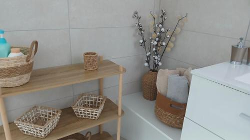 a kitchen with two shelves and baskets and a sink at VILLARGONDRAN vélos en Maurienne garage motos in Villargondran