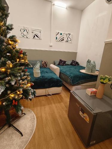 a room with two beds and a christmas tree at SridaHouse#Near Central Festival Hat Yai in Sathani Khlong Rian