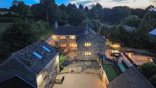 an aerial view of a large stone house at night at Habberjam Farm - Swimming pool, Hot Tub, Sauna, Games Room in Sheffield
