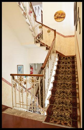 a staircase in a home with wooden railings at Hotel Eros in Lido di Camaiore