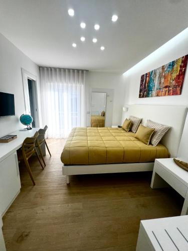 a bedroom with a large bed and a desk at Dorado Home in Scafati