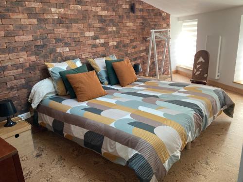 En eller flere senge i et værelse på L'atelier du faubourg