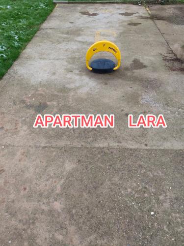 a yellow frisbee sitting on a concrete sidewalk at Apartman LARA in Pirot