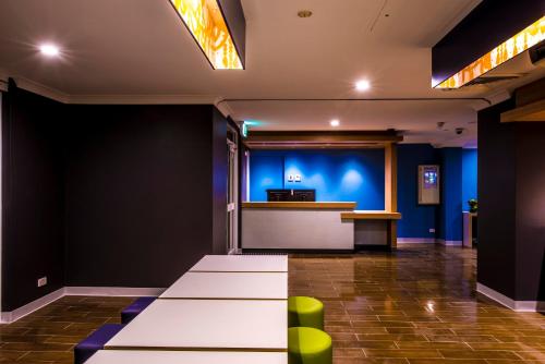 a conference room with a white table and a bar at Ibis Budget - Casula Liverpool in Liverpool