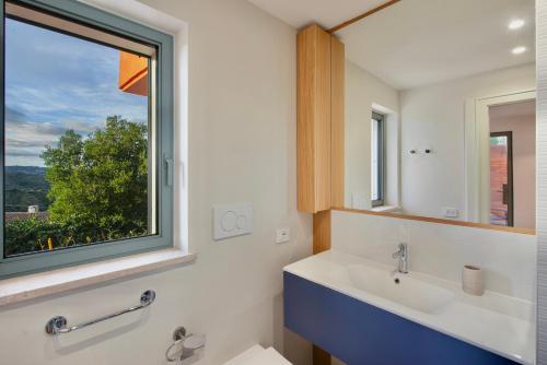 a bathroom with a sink and a window at Casa Ponente in Porto Santo Stefano
