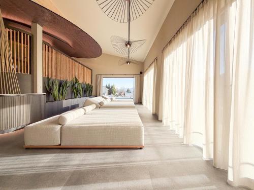 a long corridor with two beds in a room at Hotel Pehab - Rooftop-Spa in Ramsau am Dachstein