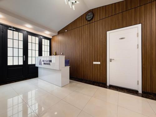a room with a white door and a sign on the wall at Musafir Hotel in Tashkent