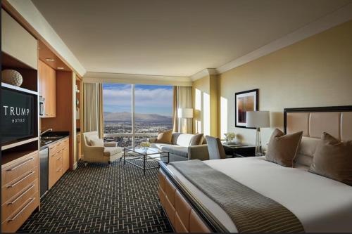 a hotel room with a large bed and a living room at Trump International Condo Hotel in Las Vegas