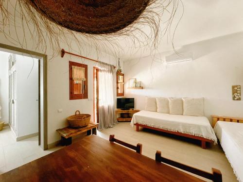 a bedroom with a bed and a living room at Michel Dos apartamentos in San Ferrán de ses Roques