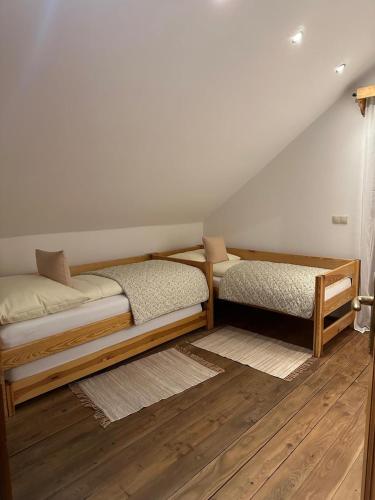 two beds in a room with a attic at Chata pri lese,Liptov in Bobrovec