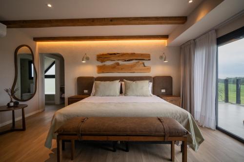 a bedroom with a large bed and a large window at Casa Pradera - Hotel Serrano in Sierra de los Padres